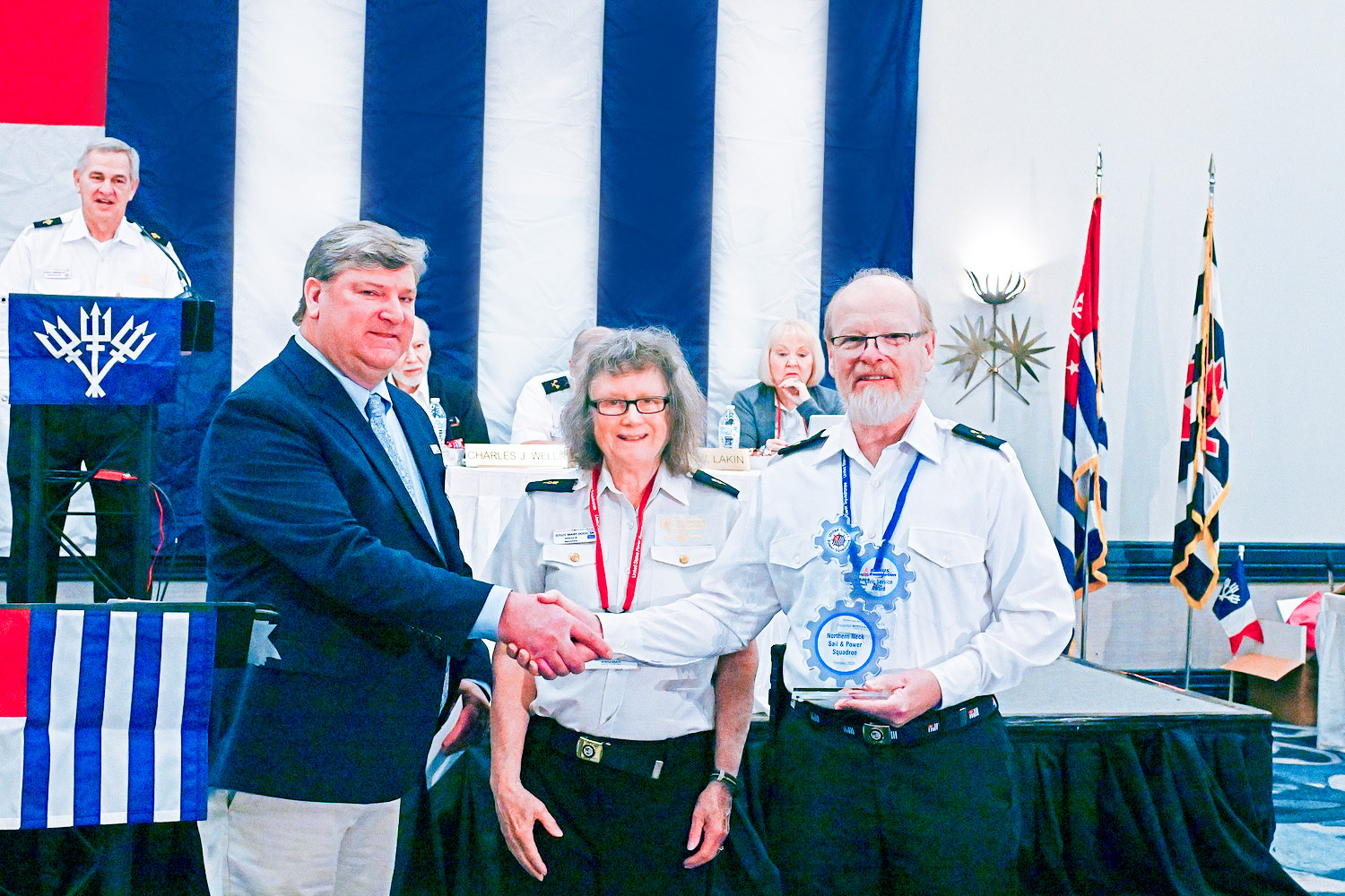 Ted Sensenbrenner, Dir of Boating Safety BoatUS Foundation, along with Stf/C Mary Dodd, SN, presents the BoatUS Civic Service Award to Cdr James Ray, SR., P of Northern Neck Sail & Power Squadron as outgoing Chief Commander Ralph Bernard, AP looks on.   